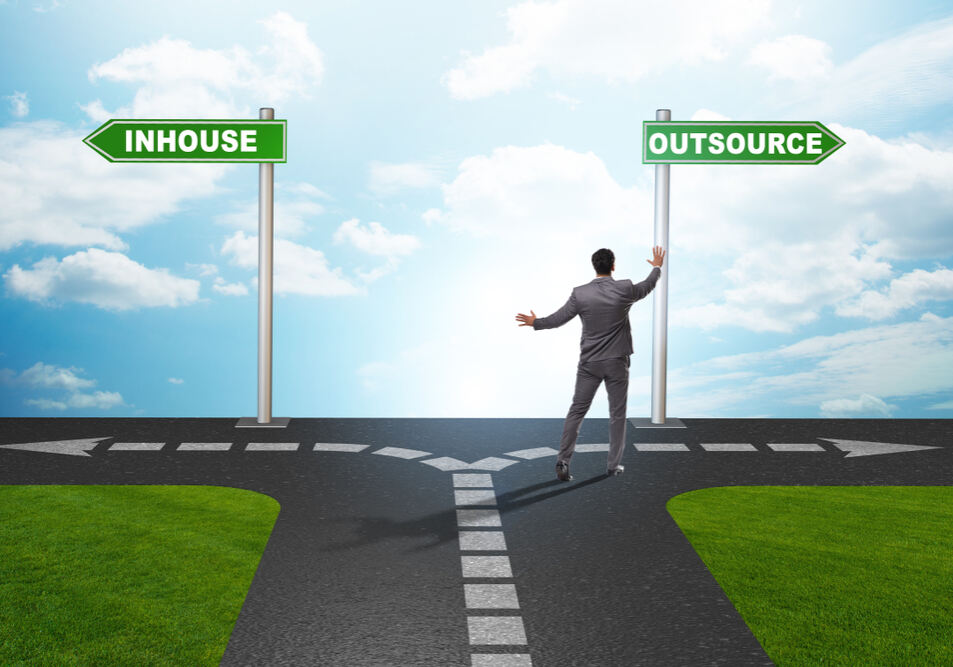 Businessman,At,Crossroads,Deciding,Between,Outsourcing,And,Inhouse